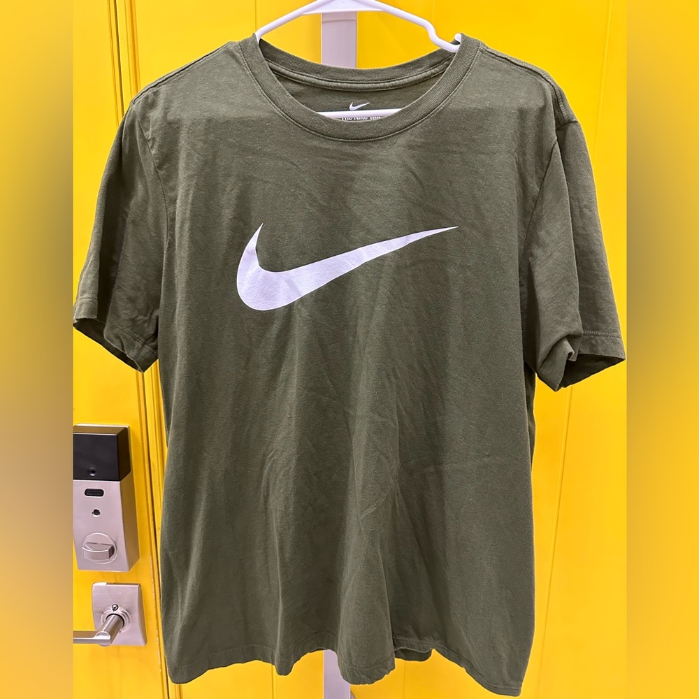 The Nike Tee army green large 3 small wholes on the front of the shirt